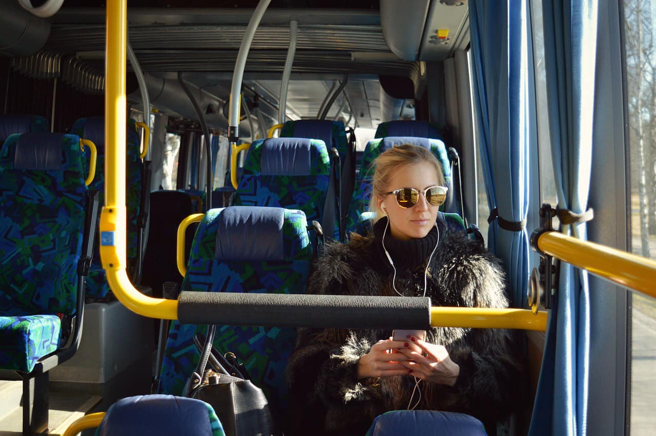 Das Bild zeigt eine junge Frau im Bus.